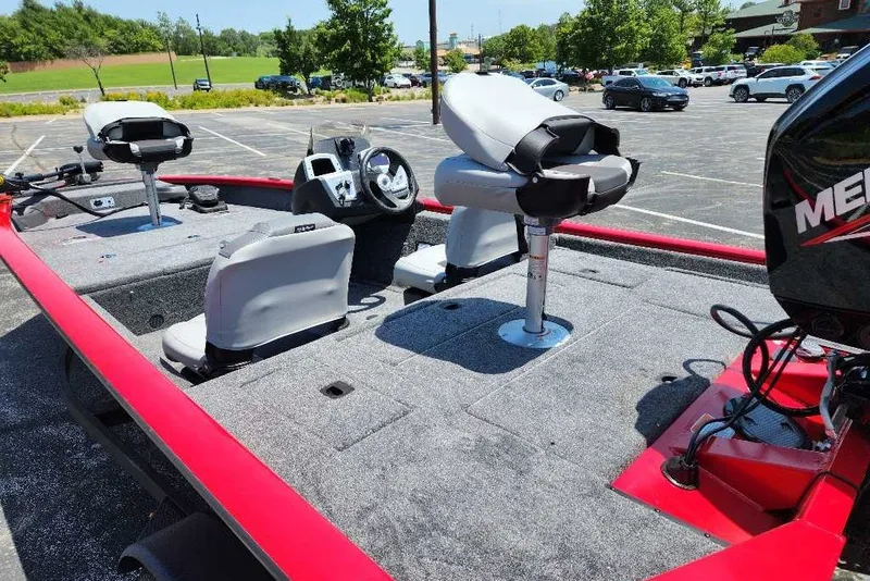 Slide: The Image of 2027 Tracker Pro Team 175 Crappie Edition boat with seating and steering console in a parking lot. - 19