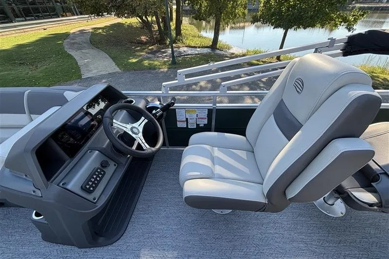 Slide: The Image of 2027 Sun Tracker Fishin' Barge 20 DLX helm with comfortable seating and steering wheel. - 25