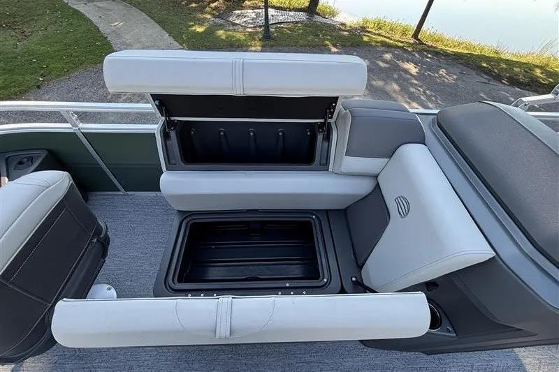 Slide: The Image of 2027 Sun Tracker Fishin' Barge 20 DLX with open storage compartments on deck. - 17