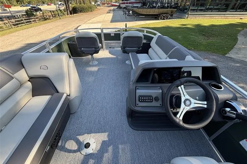 Slide: The Image of 2027 Sun Tracker Fishin' Barge 20 DLX interior with seating and steering console. - 21