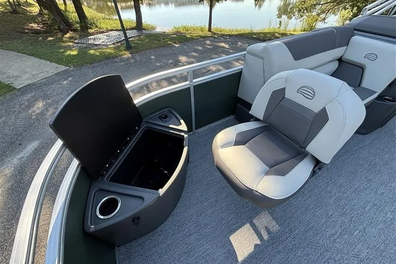 Slide: The Image of 2027 Sun Tracker Fishin' Barge 20 DLX interior with seating and storage compartment. - 15