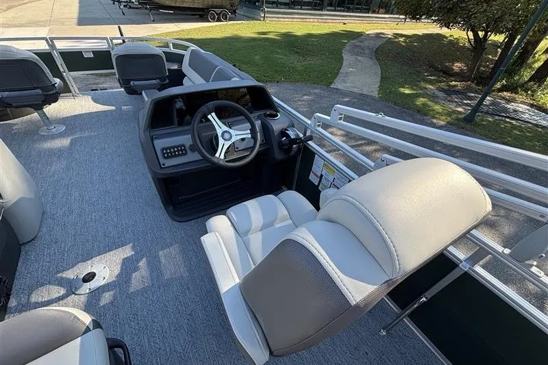 Slide: The Image of 2027 Sun Tracker Fishin' Barge 20 DLX interior with steering wheel and seating. - 26