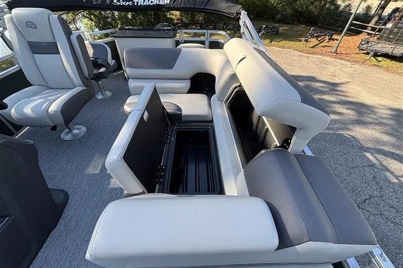 Slide: The Image of 2027 Sun Tracker Fishin' Barge 20 DLX interior with open storage compartments and seating. - 28