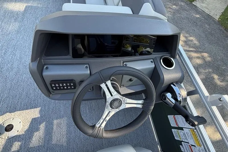Slide: The Image of 2027 Sun Tracker Fishin' Barge 20 DLX steering console with modern controls and dashboard. - 23