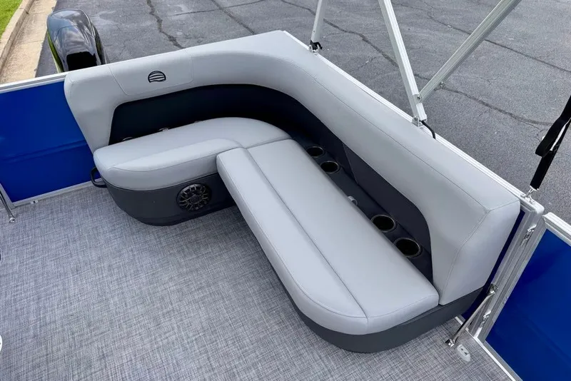 Slide: The Image of 2027 Sun Tracker Party Barge 16 DLX seating area with cup holders and gray upholstery. - 14