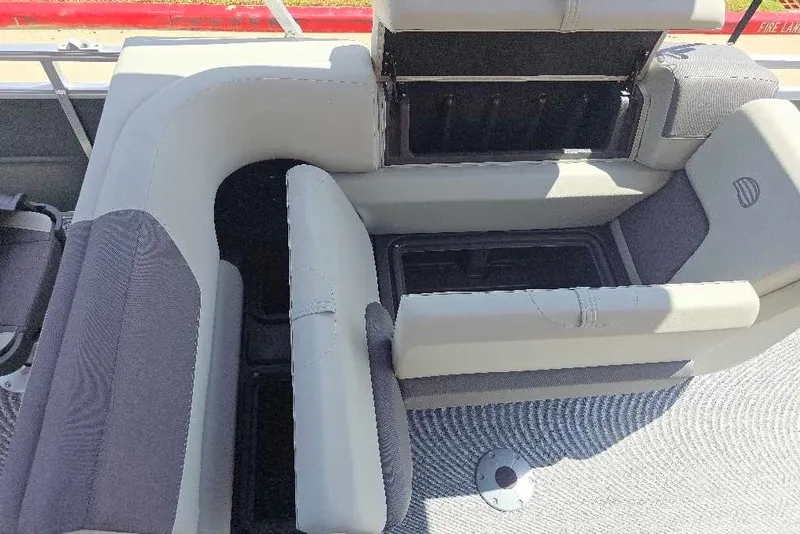 Slide: The Image of 2027 Sun Tracker Fishin' Barge 20 DLX interior seating with storage compartments. - 13