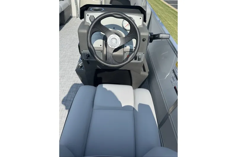 Slide: The Image of 2027 Sun Tracker Party Barge 16 DLX steering console with comfortable seating. - 13
