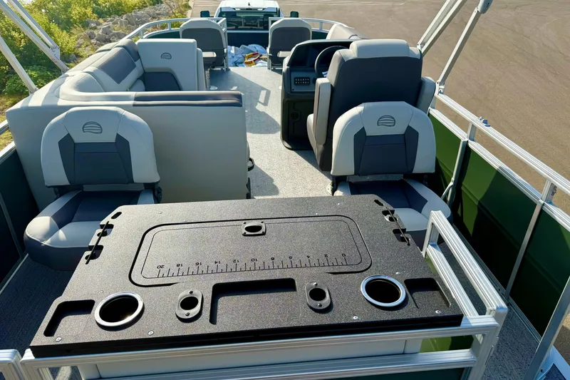 Slide: The Image of 2027 Sun Tracker Fishin' Barge 20 DLX interior with seating and fishing station. - 14