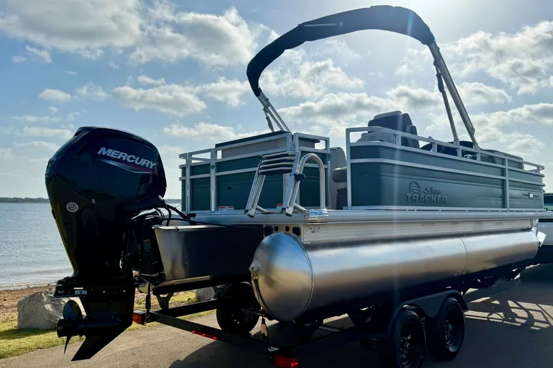 Slide: The Image of 2027 Sun Tracker Fishin' Barge 20 DLX pontoon boat with Mercury engine by the water. - 19