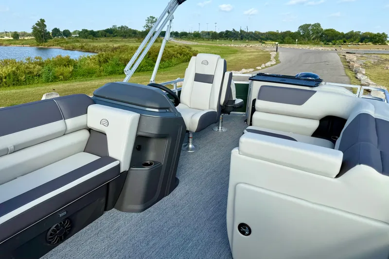 Slide: The Image of 2027 Sun Tracker Fishin' Barge 20 DLX interior with plush seating and steering console. - 12