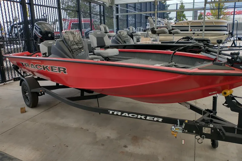 The Image of Red 2027 Tracker Pro Team 175 Crappie Edition boat on trailer in showroom. - 0