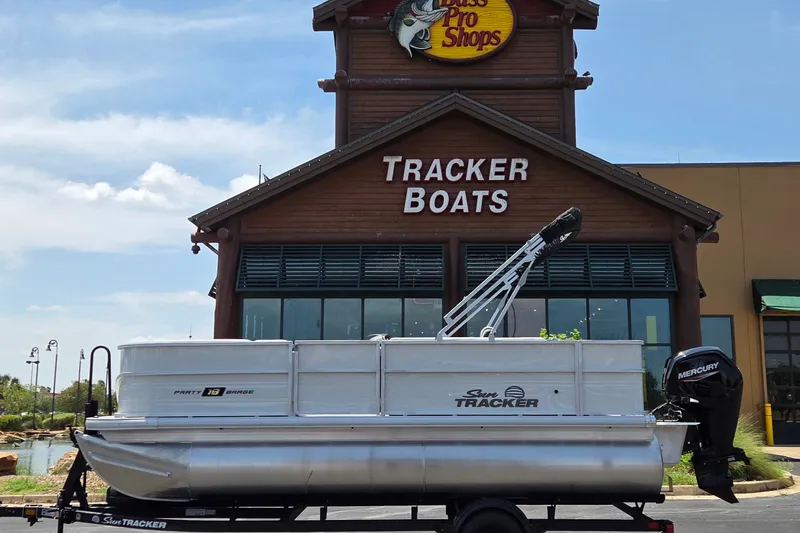 The Image of 2027 Sun Tracker Party Barge 18 DLX pontoon boat outside Tracker Boats store. - 0