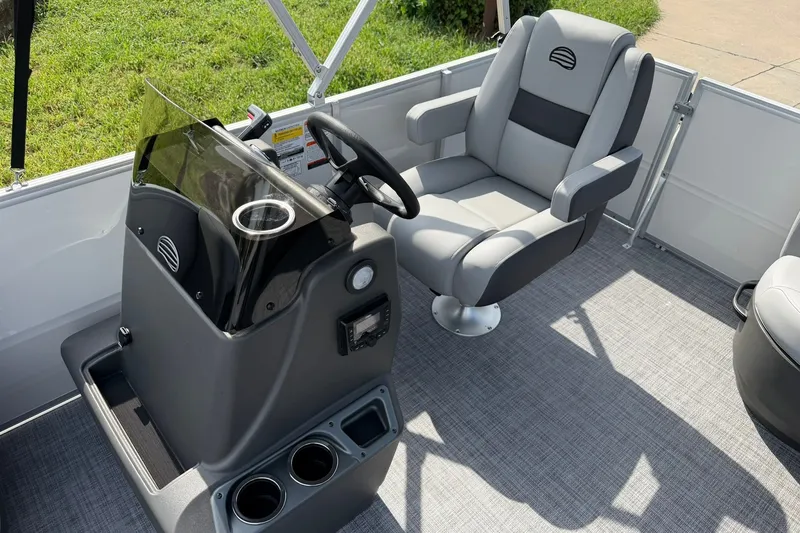 Slide: The Image of 2027 Sun Tracker Party Barge 16 DLX interior with steering console and captain's chair. - 15