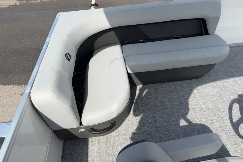 Slide: The Image of 2027 Sun Tracker Party Barge 16 DLX, featuring sleek gray seating and cup holders. - 19