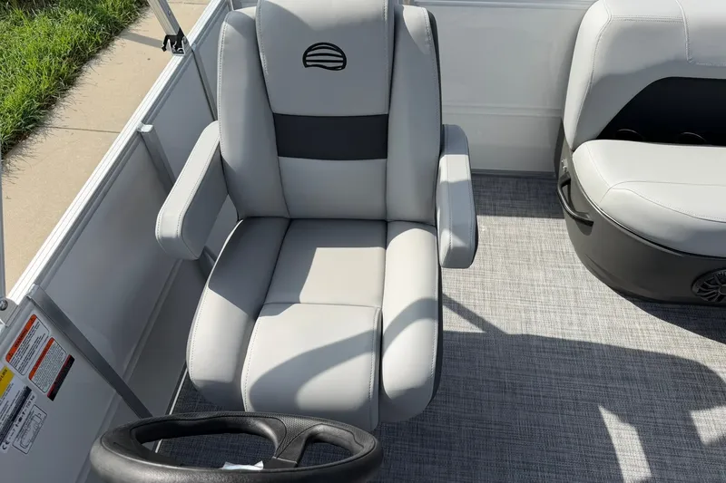 Slide: The Image of 2027 Sun Tracker Party Barge 16 DLX interior with comfortable seating and steering wheel. - 16