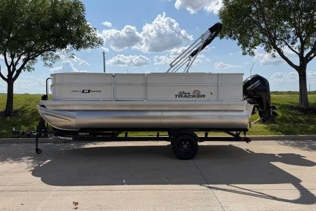 The Image of 2027 Sun Tracker Party Barge 18 DLX pontoon boat on trailer, parked outdoors. - 7