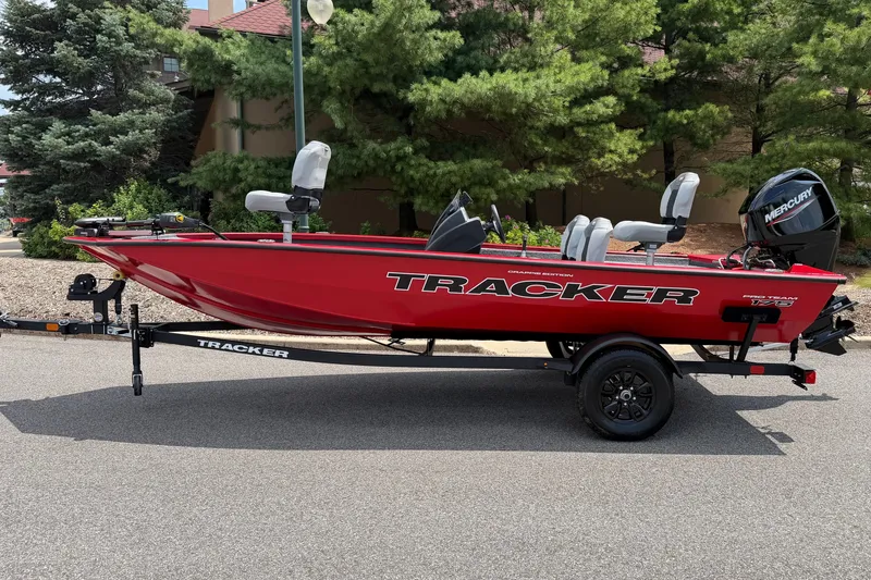 The Image of Red 2027 Tracker Pro Team 175 Crappie Edition boat on trailer, parked outdoors. - 0