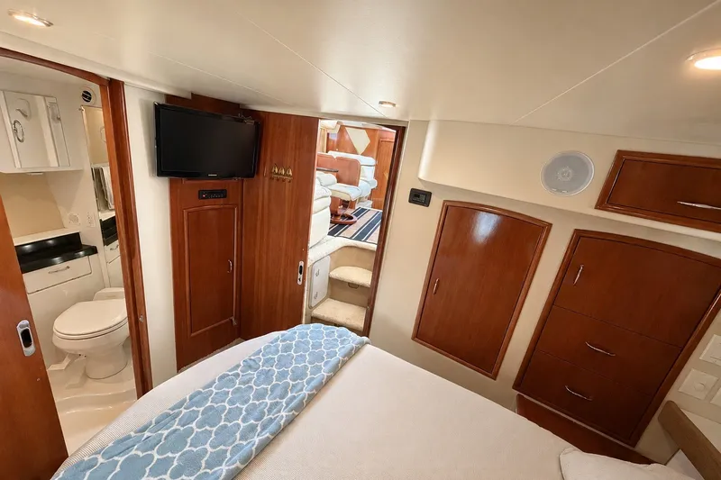 Slide: The Image of Interior of 2004 Carver 366 Motor Yacht with bedroom, bathroom, and TV. - 15