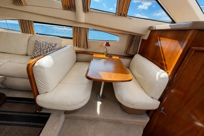 Slide: The Image of Interior of 2004 Carver 366 Motor Yacht with elegant seating and wooden table. - 14