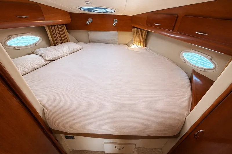 Slide: The Image of Luxurious bedroom in 2004 Carver 366 Motor Yacht with cozy bedding and wooden cabinetry. - 18