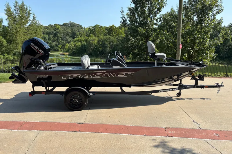 The Image of 2027 Tracker Pro Team 175 Crappie Edition boat on trailer, parked outdoors. - 0