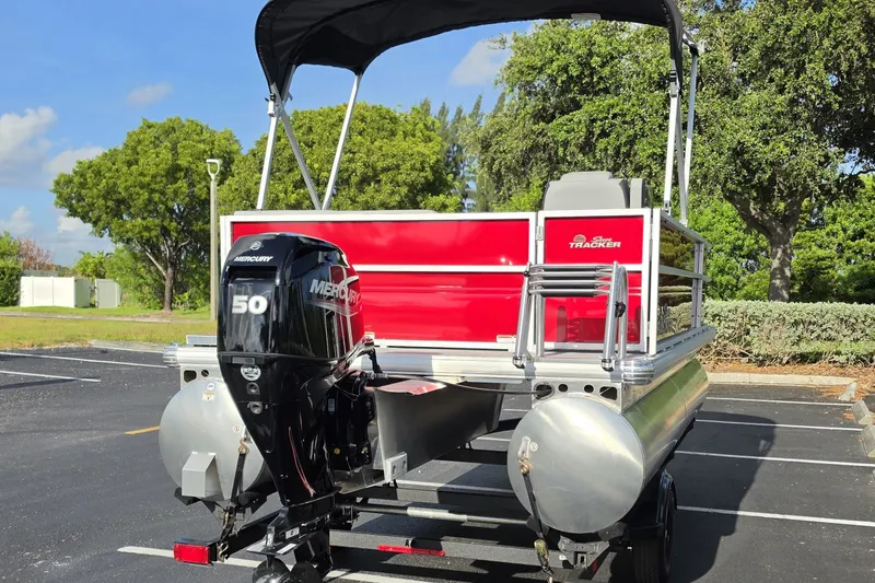 Slide: The Image of 2027 Sun Tracker Party Barge 16 DLX pontoon boat with Mercury 50 engine in parking lot. - 12