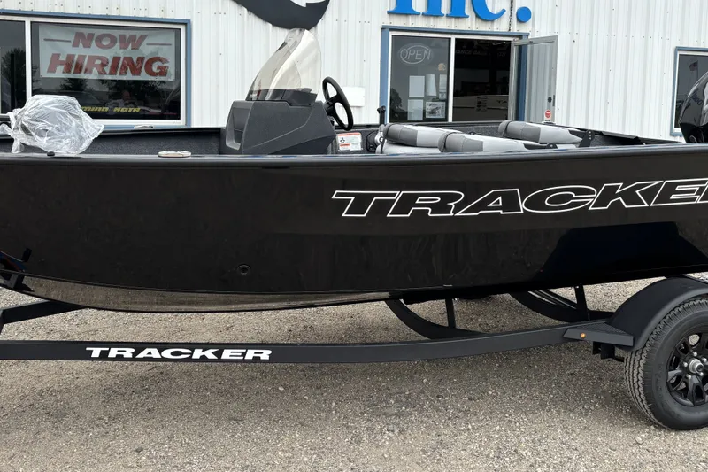 The Image of 2027 Tracker Pro Guide V-16 SC boat on trailer outside dealership. - 0