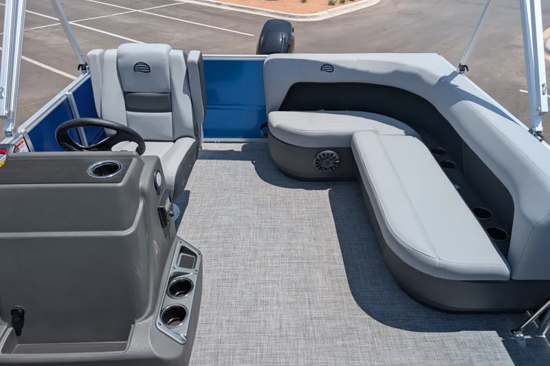 Slide: The Image of 2027 Sun Tracker Party Barge 16 DLX interior with gray seating and steering console. - 14
