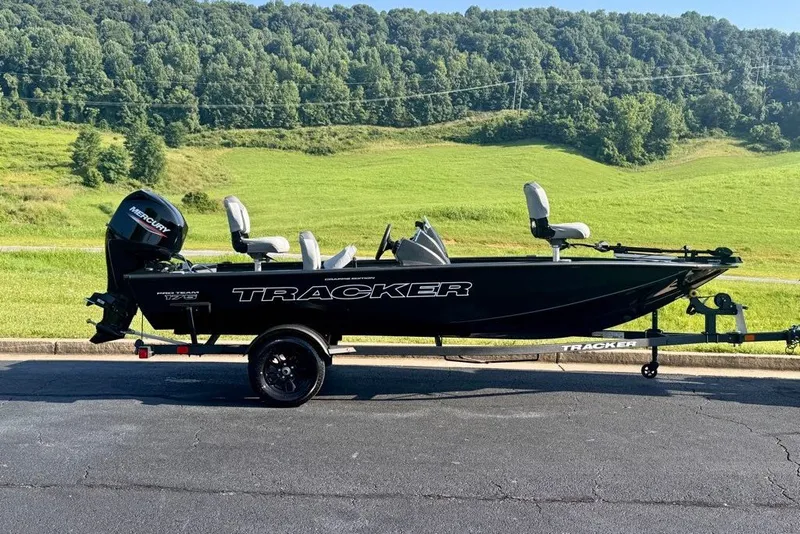 The Image of 2027 Tracker Pro Team 175 Crappie Edition boat on trailer, scenic green landscape background. - 0