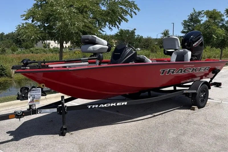 The Image of 2027 Tracker Pro Team 175 Crappie Edition boat on trailer, parked outdoors. - 0