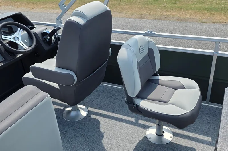 Slide: The Image of 2027 Sun Tracker Fishin' Barge 20 DLX interior with two gray captain chairs. - 32