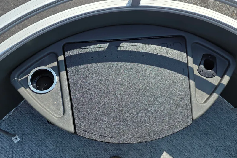 Slide: The Image of 2027 Sun Tracker Fishin' Barge 20 DLX deck with cup holder and measurement board. - 20