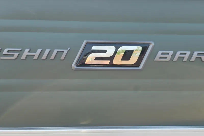 Slide: The Image of Sun Tracker Fishin' Barge 20 DLX 2027 model emblem on boat exterior. - 14