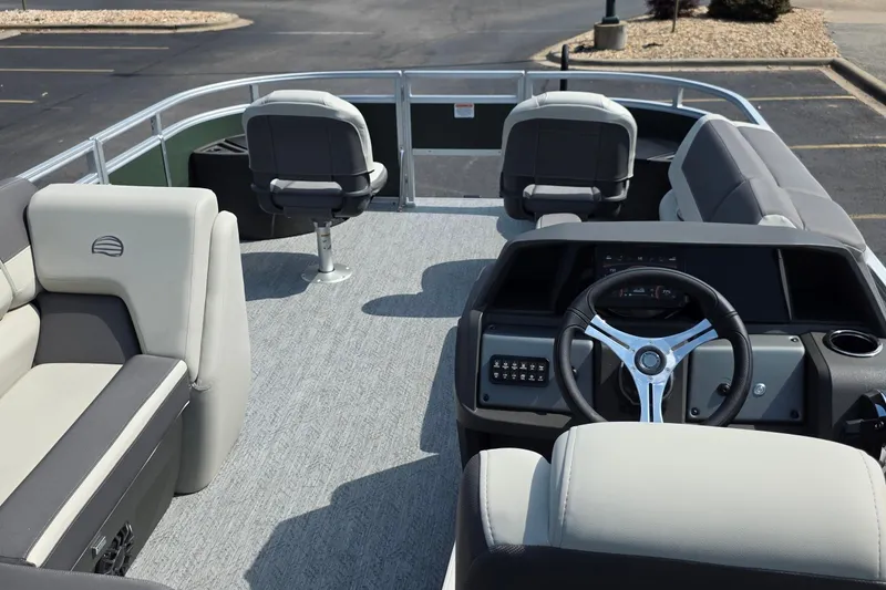 Slide: The Image of 2027 Sun Tracker Fishin' Barge 20 DLX interior with steering wheel and seating arrangement. - 23