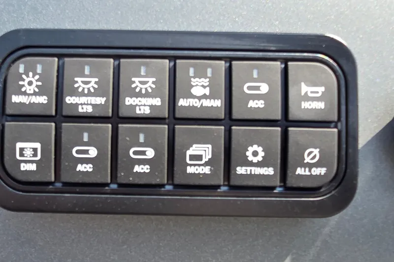 Slide: The Image of Control panel of 2027 Sun Tracker Fishin' Barge 20 DLX with various function buttons. - 13