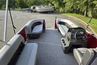 Slide: The Image of 2027 Sun Tracker Party Barge 16 DLX interior with seating and steering console. - 13