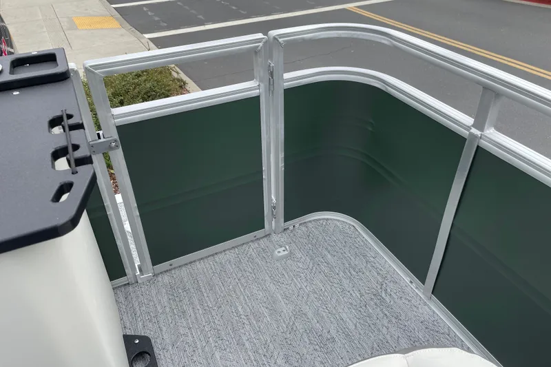 Slide: The Image of 2027 Sun Tracker Fishin' Barge 20 DLX pontoon boat interior with railing and carpeted floor. - 22