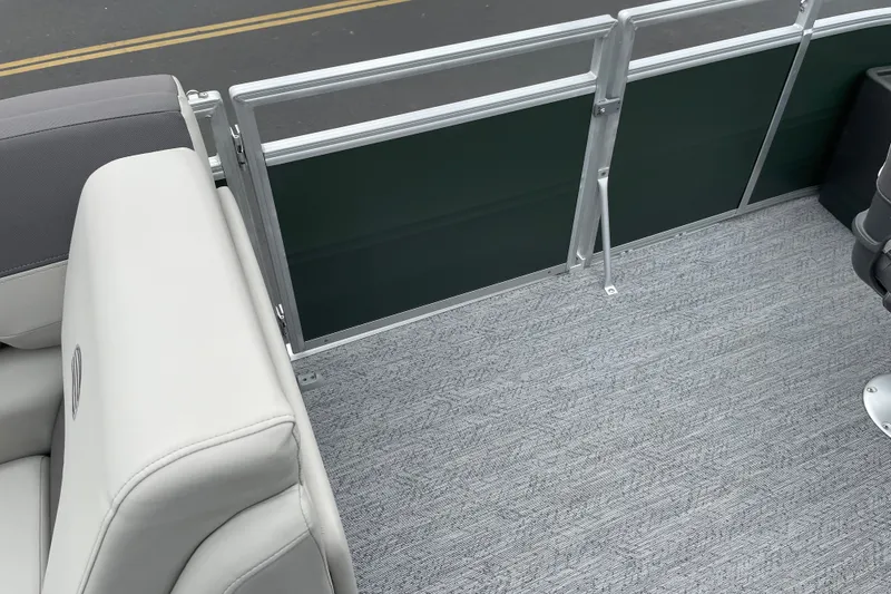 Slide: The Image of 2027 Sun Tracker Fishin' Barge 20 DLX interior with gray seating and carpeted floor. - 26