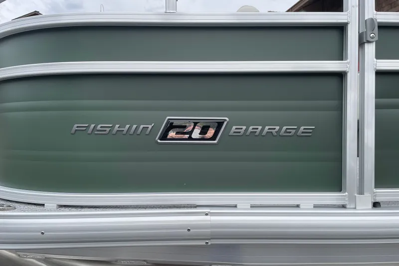 Slide: The Image of 2027 Sun Tracker Fishin' Barge 20 DLX, green exterior with logo detail. - 29