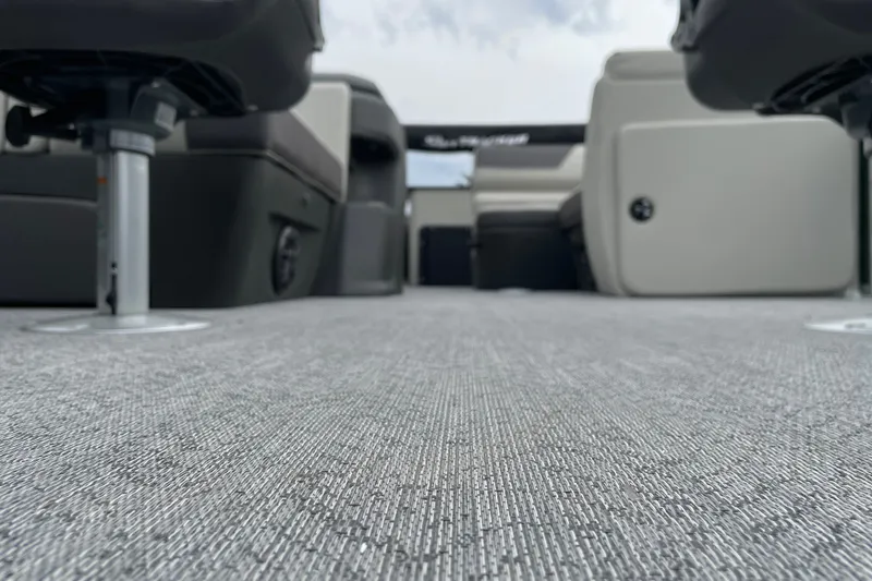 Slide: The Image of 2027 Sun Tracker Fishin' Barge 20 DLX interior with gray carpet and seating. - 28