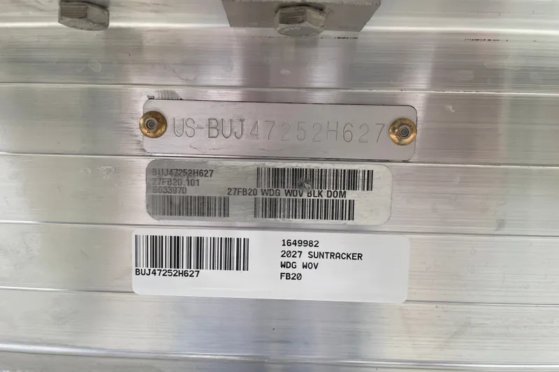 Slide: The Image of 2027 Sun Tracker Fishin' Barge 20 DLX identification plate with serial numbers and barcodes. - 83