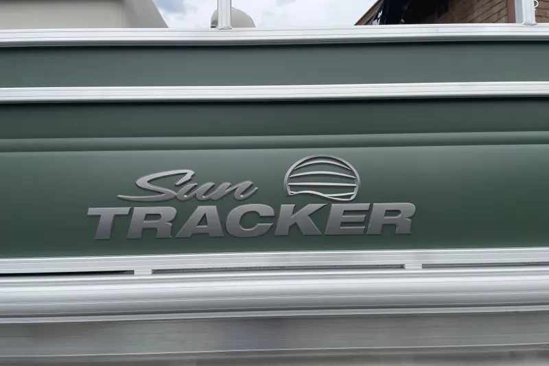 Slide: The Image of Sun Tracker Fishin' Barge 20 DLX 2027 logo on green boat exterior. - 30