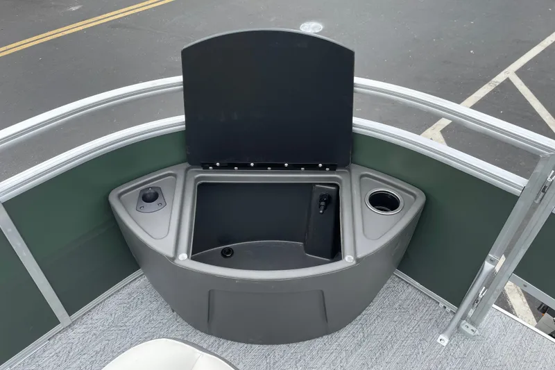 Slide: The Image of 2027 Sun Tracker Fishin' Barge 20 DLX boat with open storage compartment and cup holder. - 15