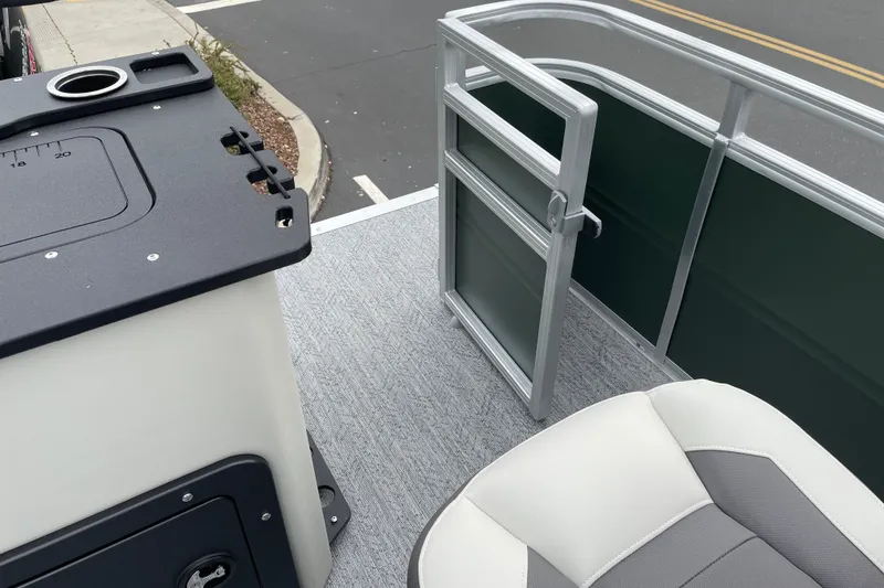 Slide: The Image of 2027 Sun Tracker Fishin' Barge 20 DLX interior with seating and railing details. - 23