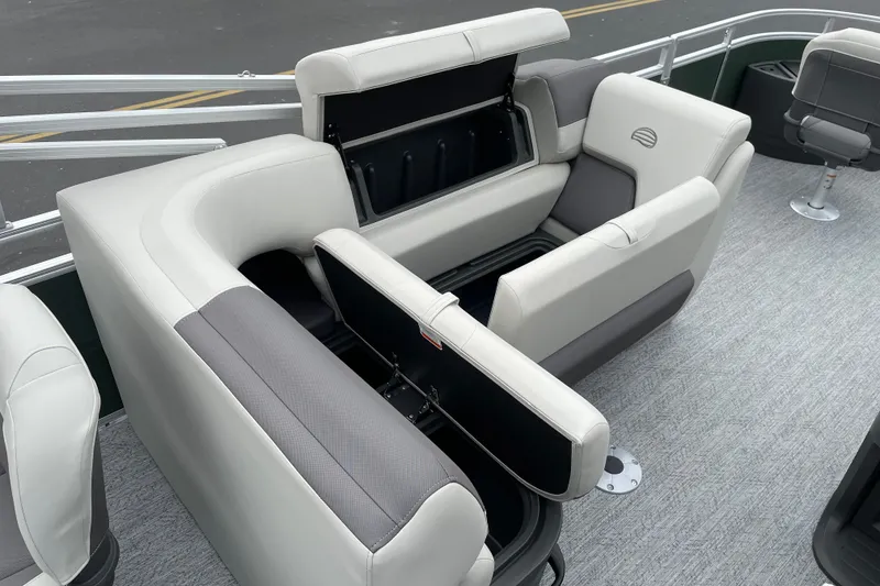 Slide: The Image of 2027 Sun Tracker Fishin' Barge 20 DLX interior seating with storage compartments open. - 18