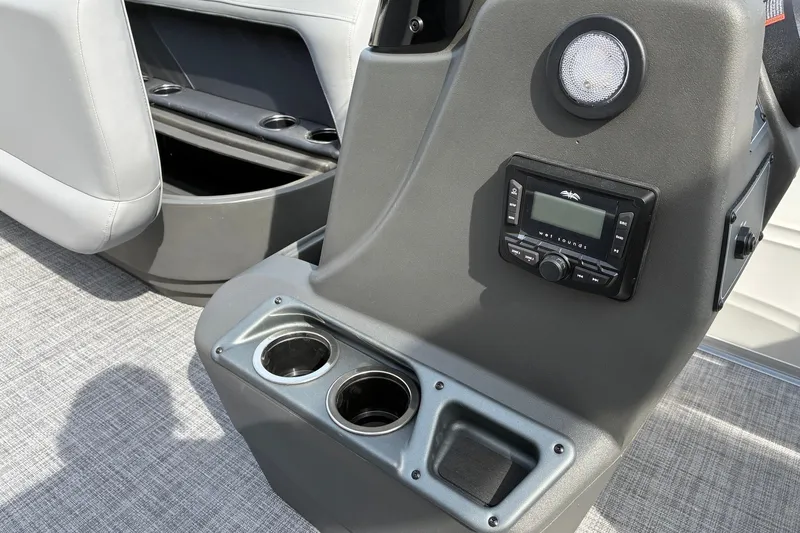 Slide: The Image of Control panel of 2027 Sun Tracker Party Barge 16 DLX with cup holders and audio system. - 13