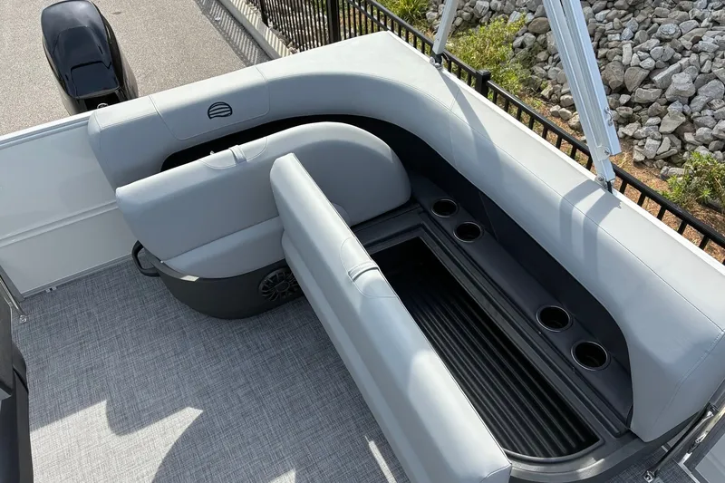 Slide: The Image of 2027 Sun Tracker Party Barge 16 DLX seating area with cup holders and storage. - 12