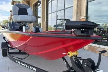 The Image of 2027 Tracker Pro Team 175 Crappie Edition boat, red hull, on trailer, outside showroom. - 0