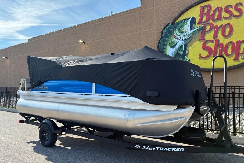 Slide: The Image of 2027 Sun Tracker Party Barge 18 DLX pontoon boat covered, parked at Bass Pro Shops. - 13