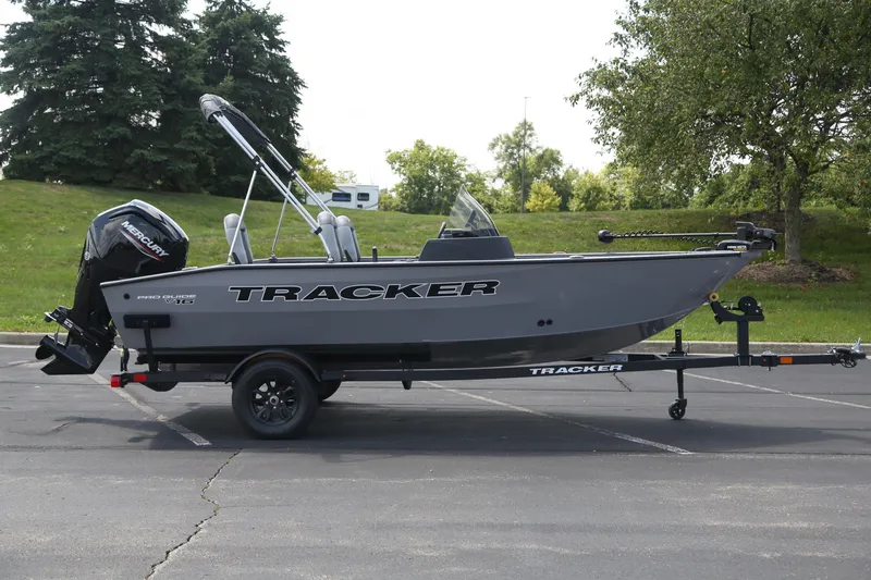 The Image of 2027 Tracker Pro Guide V-16 SC boat on trailer in parking lot. - 0